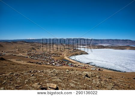 View Of Spring Landscape In Siberia With Part Of Frozen Lake Baikal In The Distance From The Top Vie
