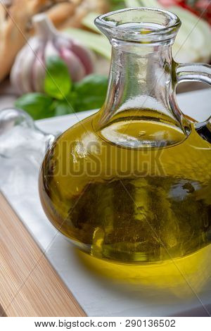 Virgin Natural Olive Oil Is Glass Bottle, Served With Traditional Mediterranean Food