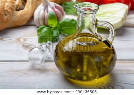 Virgin Natural Olive Oil Is Glass Bottle, Served With Traditional Mediterranean Food