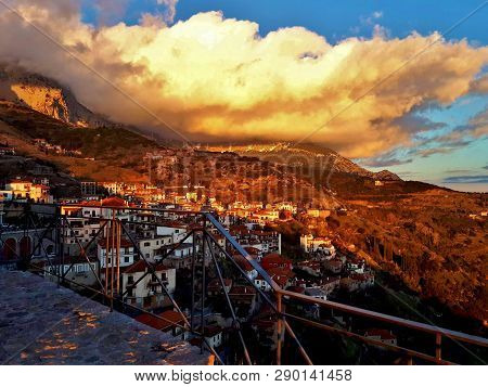 Beautiful View Of The Small Town, The Mountains And Clouds