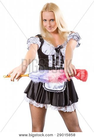 beautiful blonde in a dress of the parlourmaid and with a whisk in hands. Isolated on white