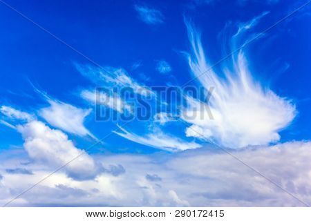 Cirrostratus cllouds of fanciful shapes in the blue sky of Australia. Journey to the ends of the earth. The concept of photo and ecological tourism