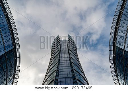 Glass Skyscrapers Of Irregular Shape. Bottom View. Abstract Architectural Detail Of Corporate Buildi