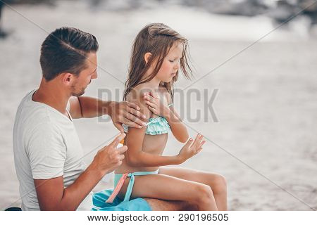 Parent Applying Sun Cream To Kid Nose. Portrait Of Lttle Girl In Suncream