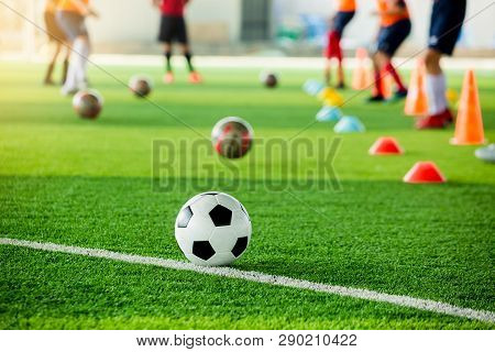 Football On Green Artificial Turf With Blurry Soccer Team Training