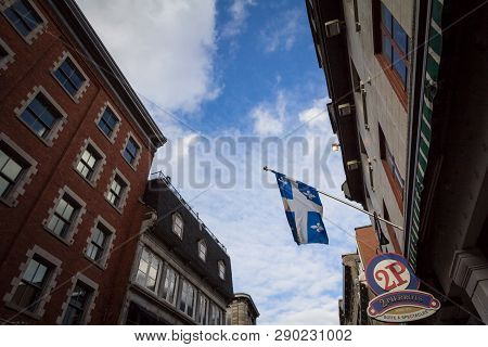 Montreal, Canada - November 7, 2018: Quebec Flag In Front Of A Restaurant In Old Montreal, Or Vieux 