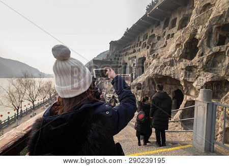 Luoyang, Henan/china- January 19, 2019: The Unspecific Woman Taking Photoat The Longmen Grottoes. Th