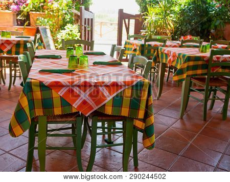 IItalian trattoria interior with wooden tables and chairs