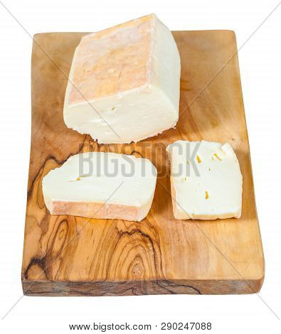 Sliced Italian Taleggio Cheese On Board Isolated