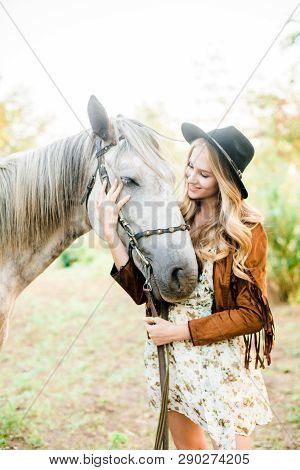 Beautiful  Young Girl With Blond Hair In A Suede Jacket With A Fringe , Wearing Black Floppy Hat, Sm