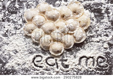 Raw Dumplings, Flouted Lie In The Shape Of A Heart On Wooden Board With Words Eat Me