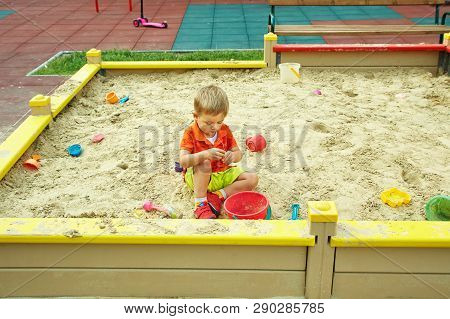 Little Boy On Playground. Playing Child In Sandbox