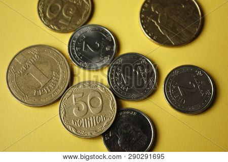 Ukrainian Coins Isolated On Yellow Background. Close-up Coins Are Located In The Center Of The Frame