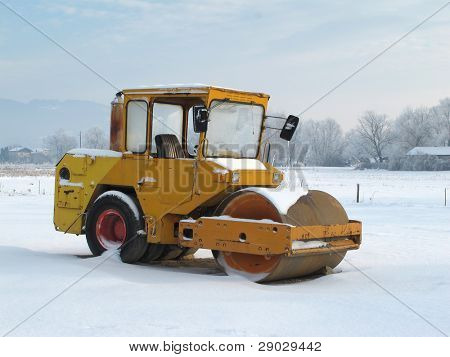 schwere gelbe Walze pneumatische Schneidverdichter unter dem Schnee