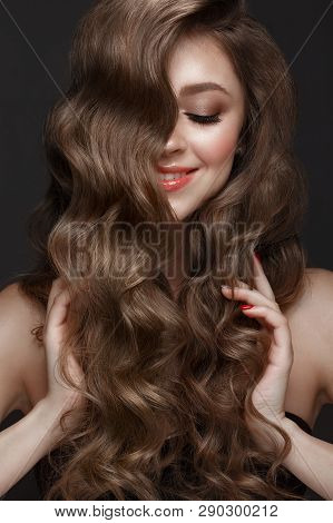 Beautiful Brown-haired Girl With A Perfectly Curls Hair, And Classic Make-up. Beauty Face.