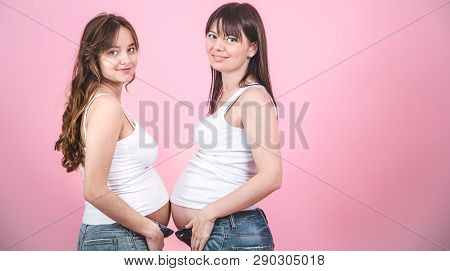 Maternity Concept, Two Pregnant Women With An Open Tummy
