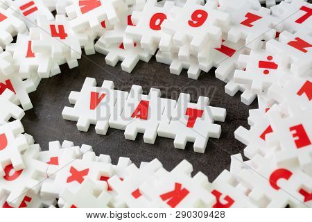Value Added Tax, Vat Concept, White Puzzle Jigsaw With Alphabet Building The Word Vat At The Center 