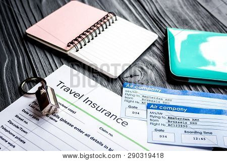 Traveling Concept With Insurance Application And Passport On Wooden Table