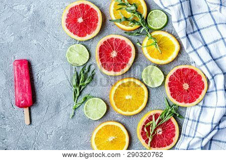 Citrus Popsicles With Fruit Slices On Stone Background Top View