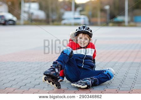 Little School Kid Boy Skating With Rollers In The City. Child In Protection Safety Clothes. Active S