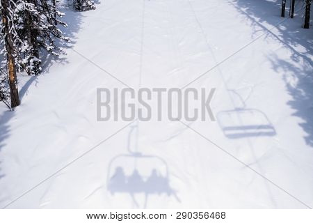 Shadow of Ski lift on a snowy slope.