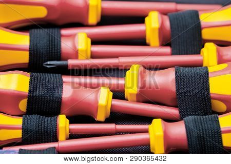 A Set Of Screwdrivers Red-yellow Color Lying In The Case, A Professional Tool