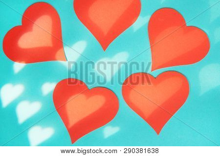 Blue Background With Red Hearts. Gobo Mask Light Effect In The Shape Of A Heart.