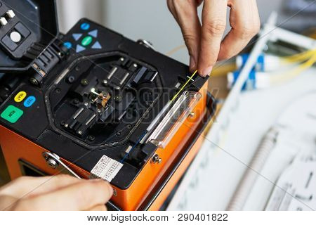 Worker Comunicate Fiber Optic Cable At Opto Box. Installing New Network Equipment.