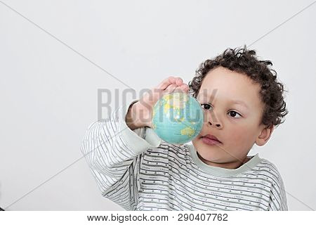 Boy Holding A Big Globe On His Head With White Background Stock Photo