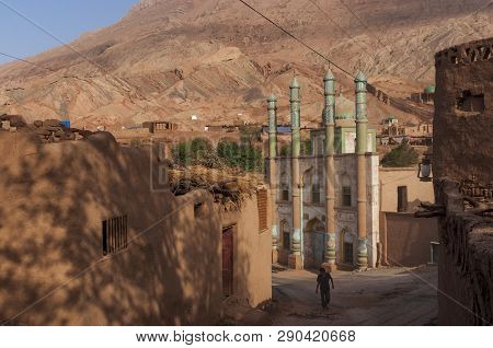 Tuyog, Turpan, China - August 12, 2012: A Man Passing In Front Of The Mosque At The Uyghur Village O
