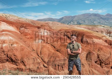 Relaxing man in Valley of Mars landscapes in the Altai Mountains, Kyzyl Chin, Siberia, Russia