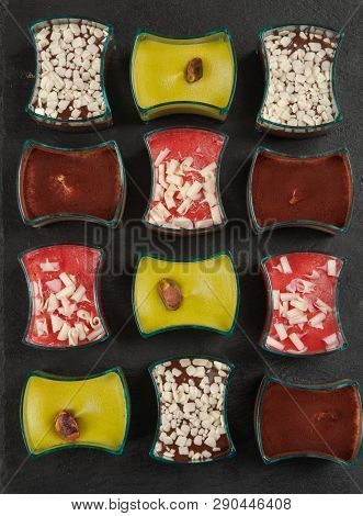 Mini Dessert. Tasty Small Portions Of Tiramisu, Chocolate And Strawberry Dessert On Dark Background.