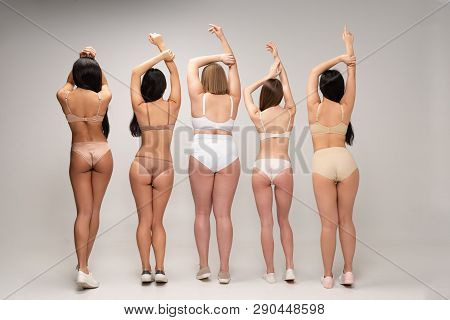 Back View Of Five Multiethnic Women In Underwear With Raised Hands, Body Positivity Concept