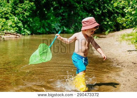 Small Child Catches Fish And Frogs In The River