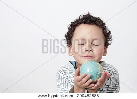 Boy Holding A Big Globe On His Head With White Background Stock Photo