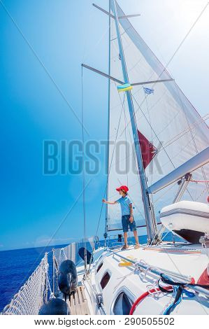 Little Boy On Board Of Sailing Yacht On Summer Cruise. Travel Adventure, Yachting With Child On Fami