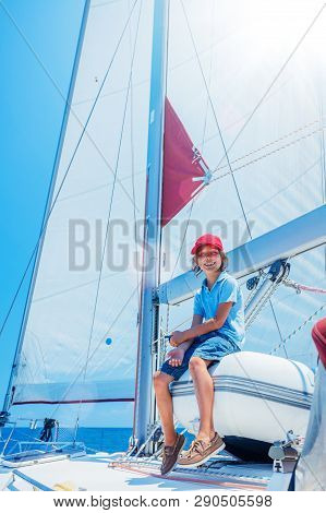 Little Boy On Board Of Sailing Yacht On Summer Cruise. Travel Adventure, Yachting With Child On Fami
