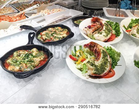 Cooked Tasty Seafood, Big Lobsters, Prawns With Fresh Paprika, Tomatoes And Greens On Bed Of Cold Ic