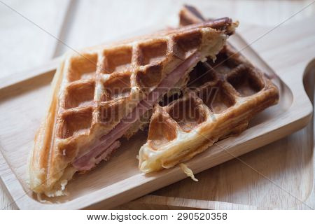 Close Up Of Waffle Ham Cheese Sandwich On Wooden Tray