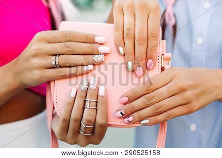 Close Up Of Bag With Girls Hands With Manicure Over It.