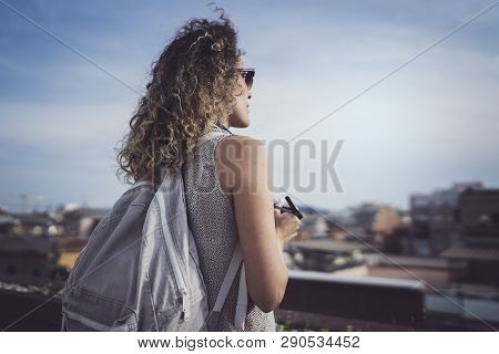 Hansome Young Woman Curly Hair And Casual Wear Enjoing Beautiful View Of The City On Sunset.