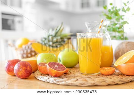 Multifruit Juice And Fresh Fruit On Table On Kitchen Background Closeup