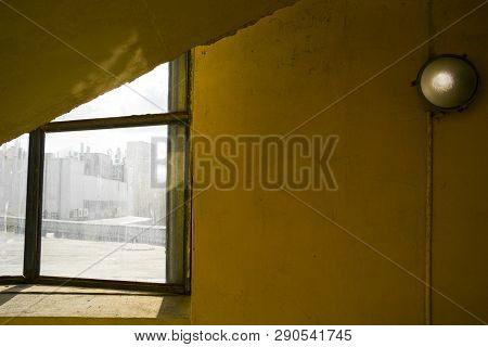 Grunge Yellow Concrete Wall And Light Goes Throgh The Window