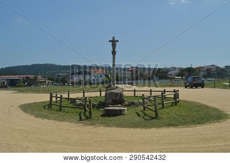 Stone Crucifix At The Entrance Of The Hermitage Of Our Lady Of The Lanzada In Noalla. Nature, Archit