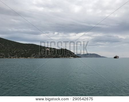 View From The Yacht To The Island With The Traditional Architecture In The Greek Style