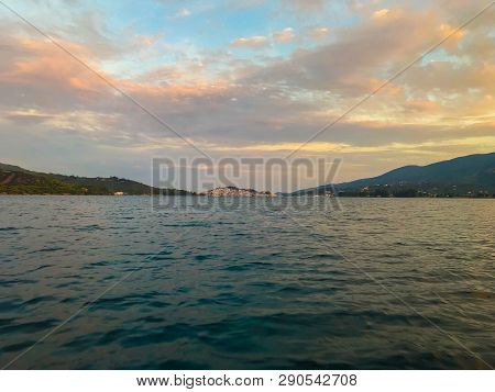 View From The Yacht To The Island With The Traditional Architecture In The Greek Style