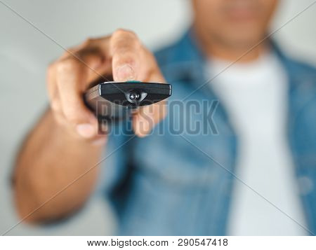 Closeup Of A Man Pess The Remote Controller Button On White Background