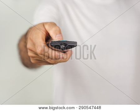 Closeup Of A Man Pess The Remote Controller Button On White Background