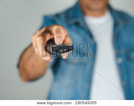Closeup Of A Man Pess The Remote Controller Button On White Background
