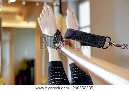 Gym Woman Pilates Stretching Sport In Reformer Bed Instructor Girl. Legs Close Up